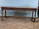 a wooden table with a drawer underneath it on a hard wood floor