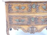 a wooden chest of drawers with ornate carvings on it
