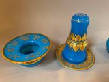 two blue vases and a blue candle holder on a table