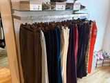 a lot of pants hanging on a rack in a store