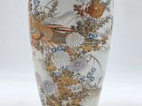 a vase with a bird and flowers painted on it