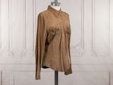 brown sued jacket with fringes on a mannequin base