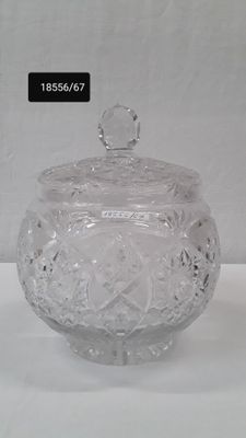 an image of a clear glass jar with a lid on a table
