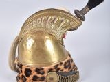 an old helmet with a black horn and leopard print on it