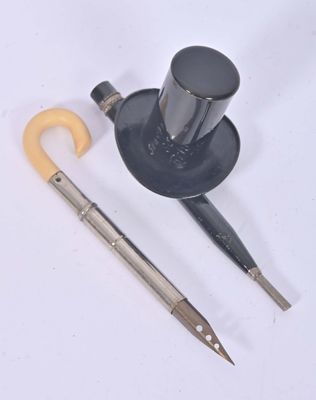 a picture of a pair of scissors and a hat on a white surface