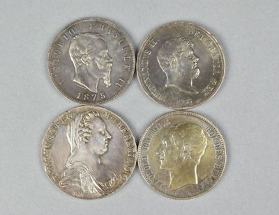 four different british coins sitting side by side on a white surface