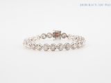 a white gold bracelet with diamonds on a white background