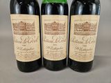 three bottles of wine sitting on top of a table next to each other