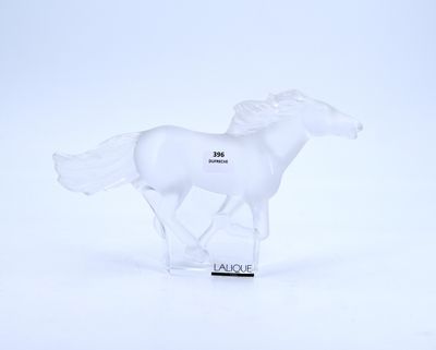 a white horse figurine that is standing on a white surface