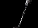 a close up of a cordless vacuum cleaner on a black background