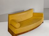 a yellow couch that is sitting on a white floor