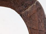 a close up view of a wooden chair with a curved seat