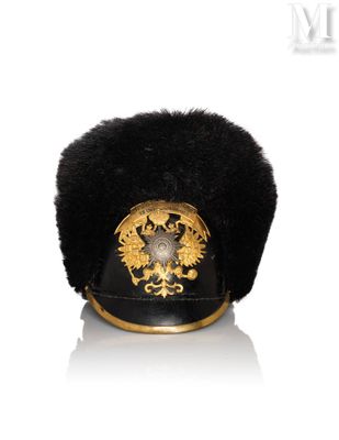a black hat with a gold emblem on it