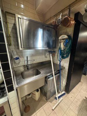 a kitchen with a stainless steel sink and stainless steel cabinets