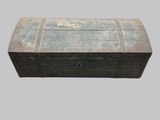 an old wooden chest with a metal lid on a gray background