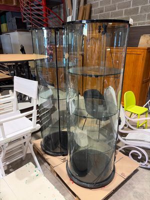 two tall glass vases sitting on top of a table