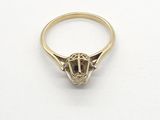 a close up of a gold ring on a white surface