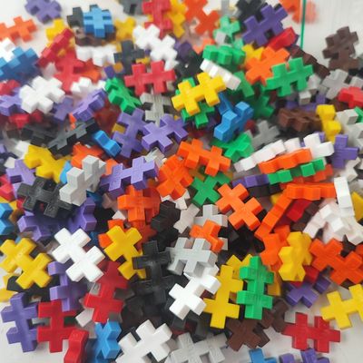 a pile of puzzle pieces on a white surface