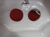 un lavabo en porcelaine blanche orné de deux cercles rouges