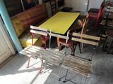 a table and chairs in a room with a yellow table top