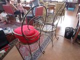 a red chair in the middle of a room full of people