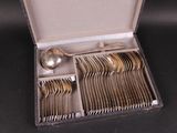 a box with silverware inside of it on a table