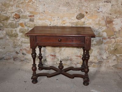 a small wooden table with a drawer on top of it