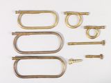 a lot of brass hardware on a white surface