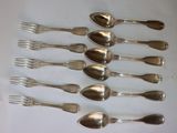 a lot of silver spoons and forks on a table