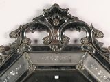 a mirror that has a silver frame on it