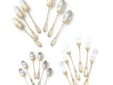 a lot of silver spoons and forks arranged in a circle