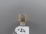 a close up of a ring with a tag on a table