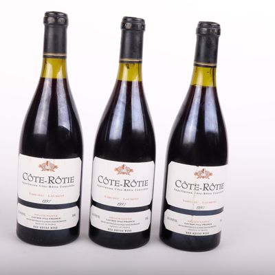 three bottles of wine sitting next to each other on a white surface