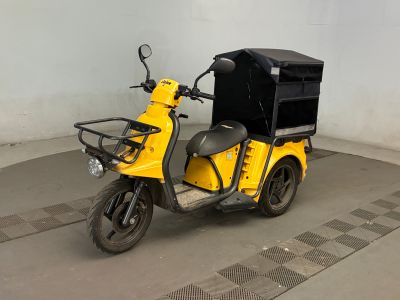 une moto jaune avec un coffre noir à l'arrière