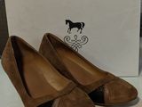 pair of women ' s brown sued shoes with black trim