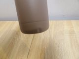 a brown cup sitting on a wooden table