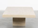 a beige square coffee table with a square base and a square top
