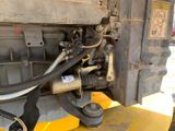 an image of a truck with a hose attached to the back of it