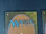 two magic the gathering cards on the table