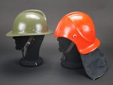two helmets are sitting side by side on a mannequin head