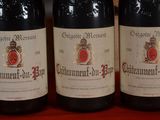 three bottles of wine sitting on top of a table next to each other