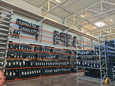 a man that is standing in front of a rack of tires