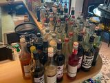 many bottles of alcohol sitting on a counter in a restaurant