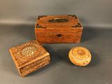 an old wooden box with a lid and a small wooden box with a lid