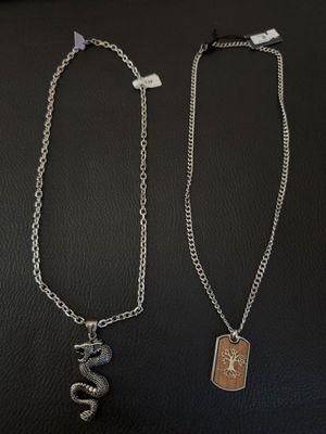 a couple of necklaces that are sitting on top of a table