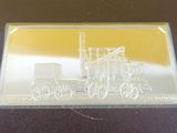 a close up of a silver plate with a train on it