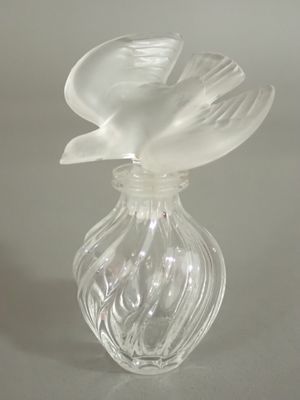 a glass vase with a flower inside of it