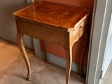 a small wooden table with a drawer on top of it