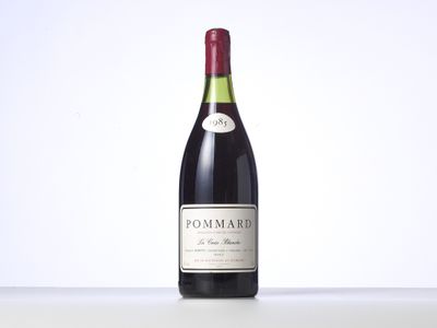 a bottle of red wine sitting on top of a table