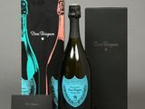 a bottle of champagne and a box of chocolates on a table